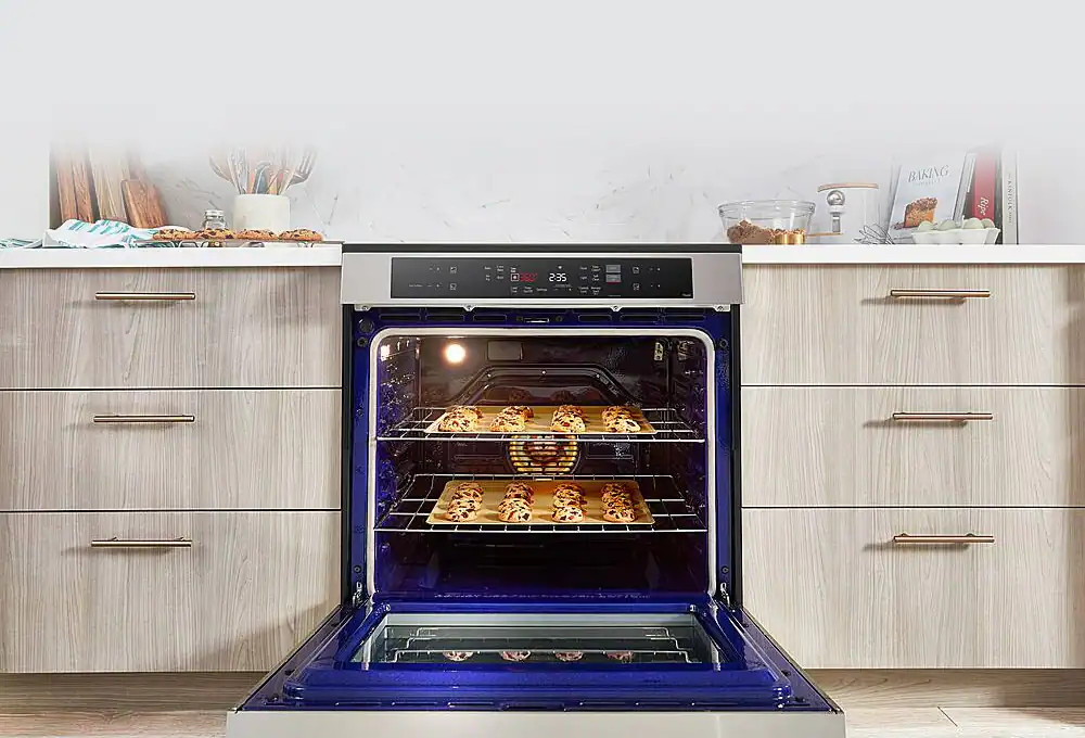 Oven not heating up at all, showing a person checking the oven interior
